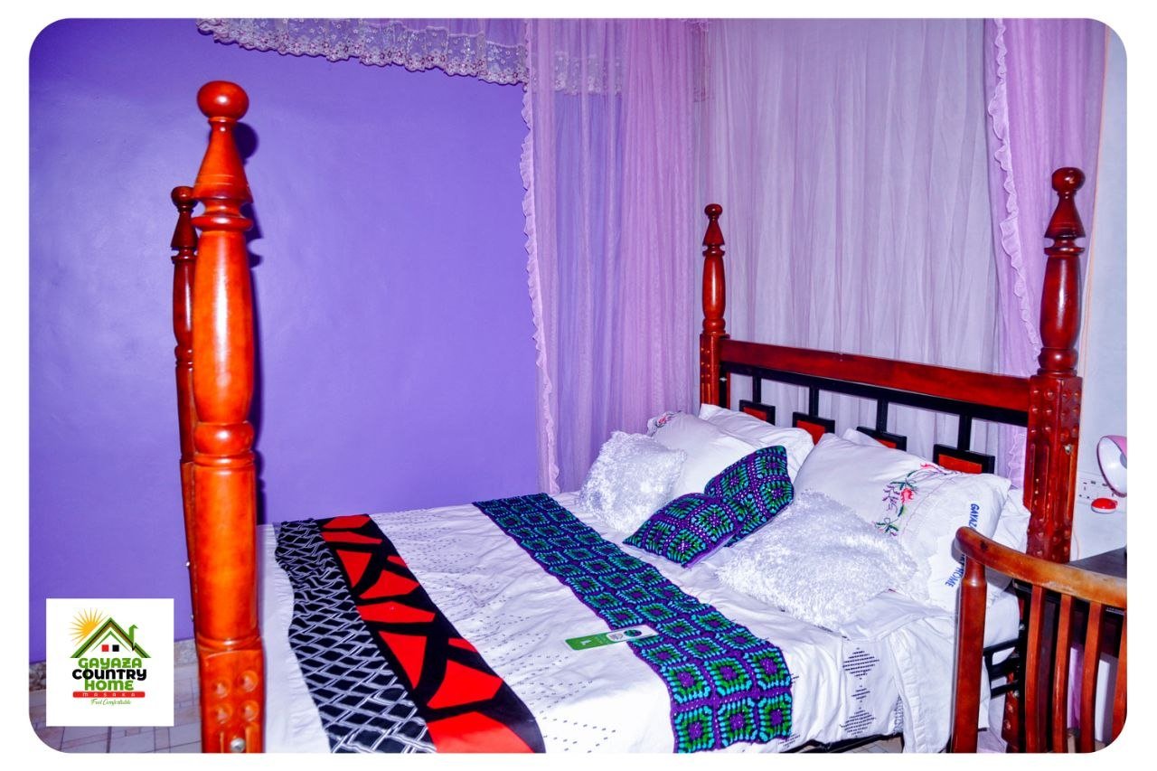 Four-poster bed with lavender wall